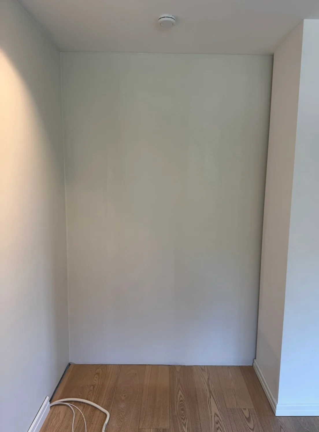 Empty interior alcove with white drywall walls