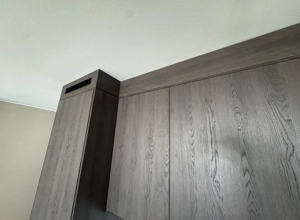 Modern built-in wardrobe with grey wood panels