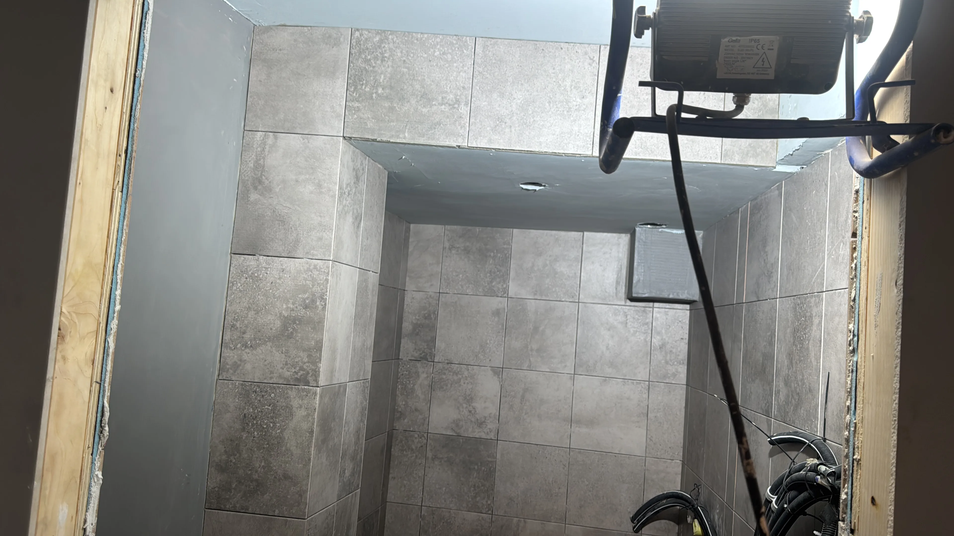 Modern bathroom renovation with grey tile installation