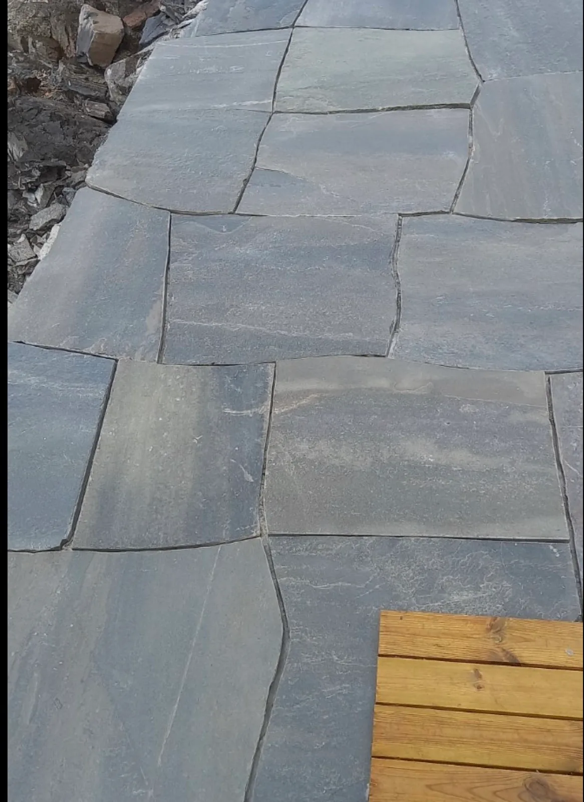Slate patio terrace with wooden border