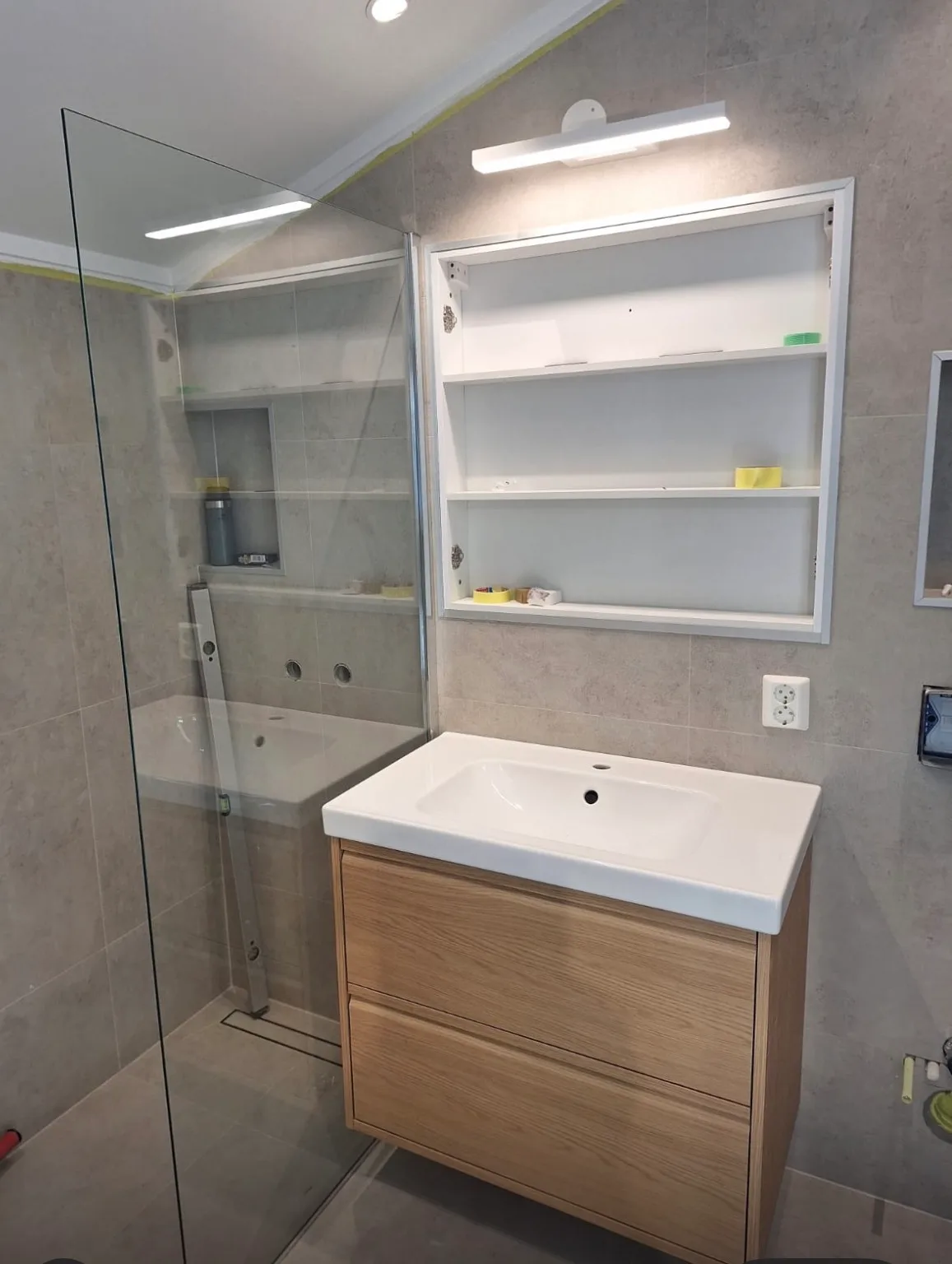 Modern bathroom with white sink and glass shower