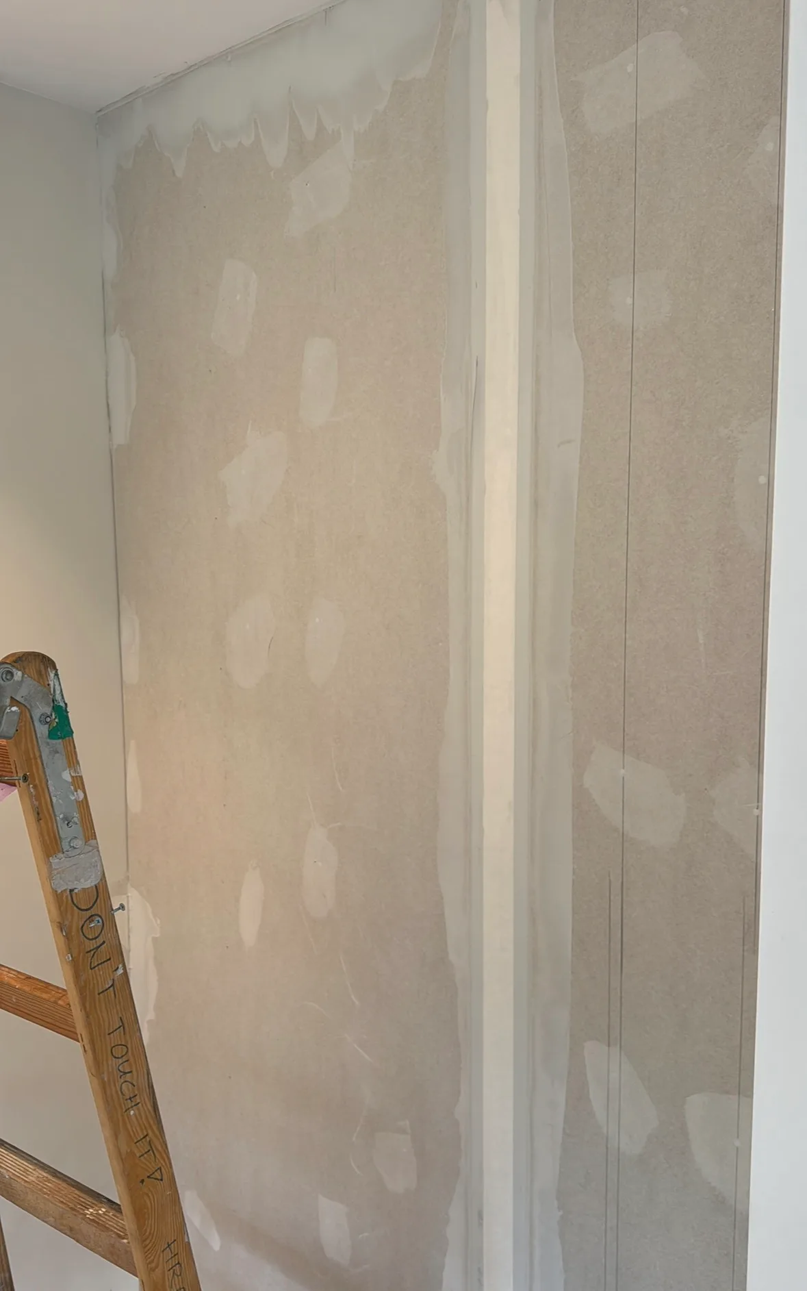 Drywall finishing with joint compound applied