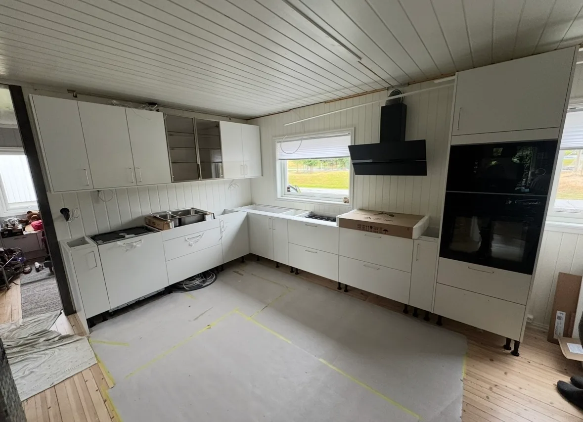 Modern white kitchen installation with black appliances