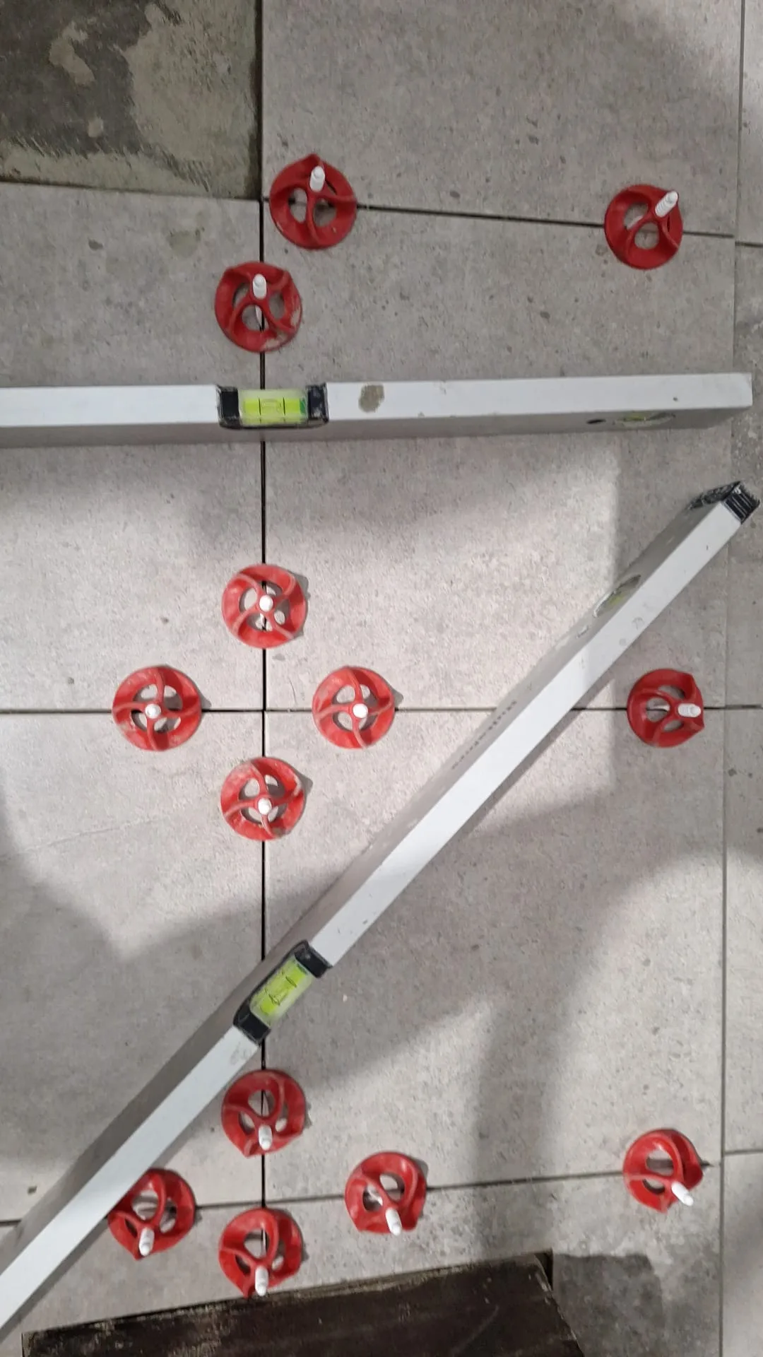 Floor tile installation with leveling tools
