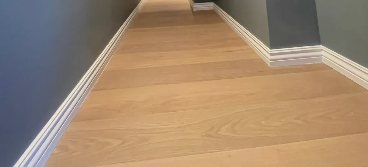 Wooden laminate flooring installation in hallway