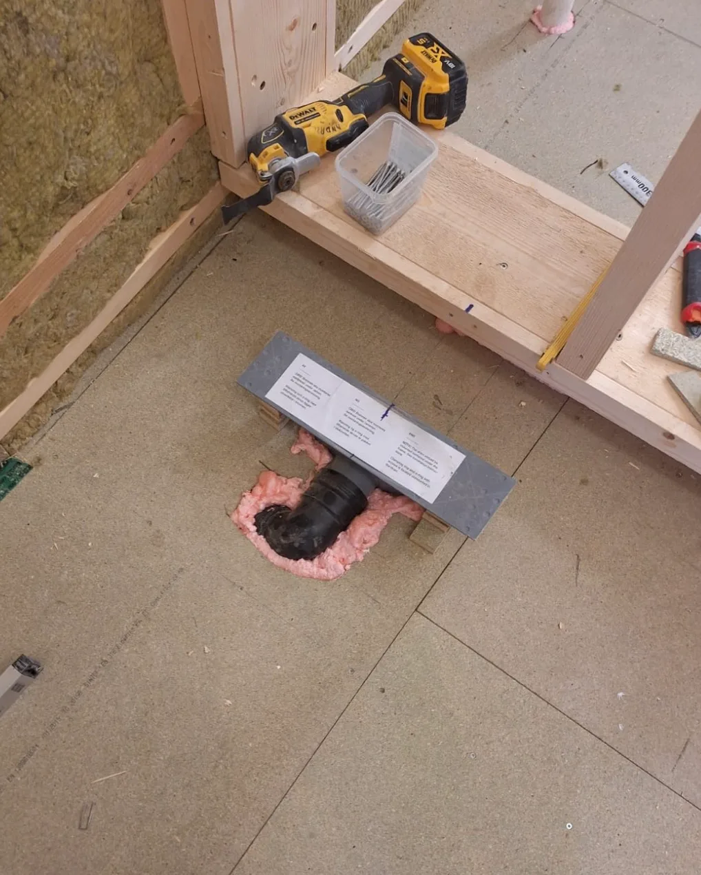 Baderomsrenovering med installert avløp og verktøy i forkant